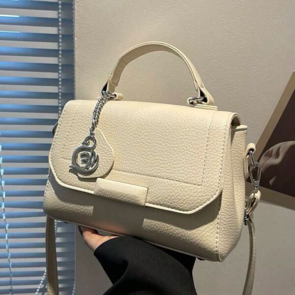 Elegant Textured Leather Handbag With Chain Charm Accent