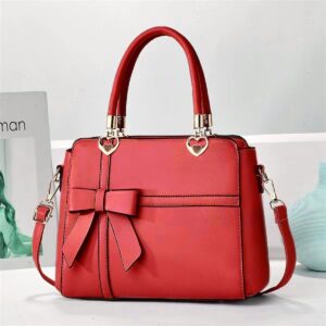 Elegant Bow-adorned Satchel Handbag With Heart Charm Handles And Removable Shoulder Strap