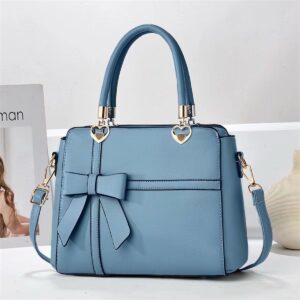 Elegant Bow-adorned Satchel Handbag With Heart Charm Handles And Removable Shoulder Strap
