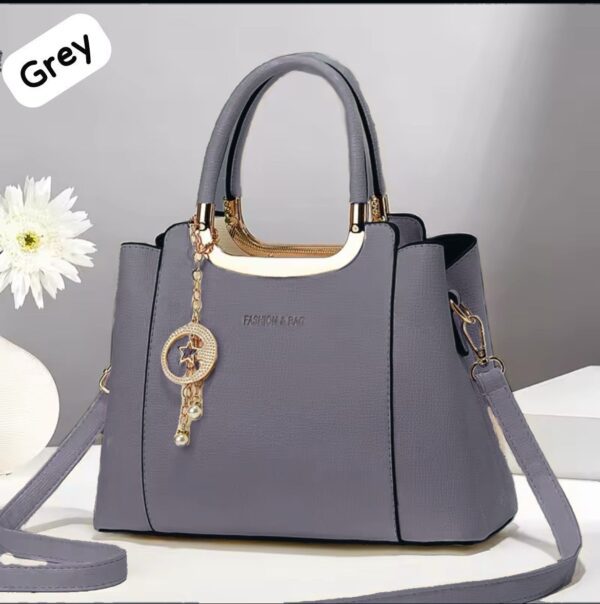 Elegant Handbag with Star Charm Pendant and Structured Design
