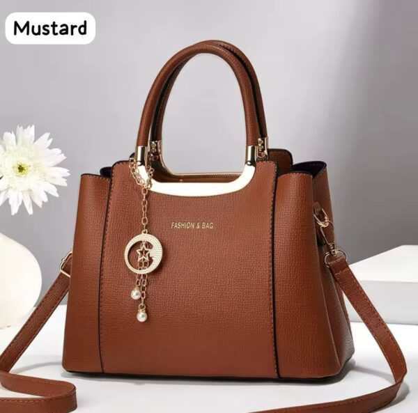 Elegant Handbag with Star Charm Pendant and Structured Design