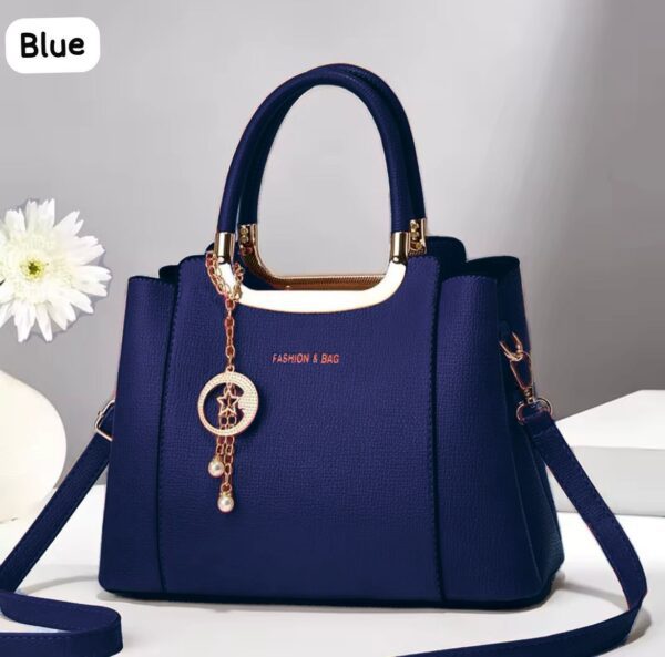 Elegant Handbag with Star Charm Pendant and Structured Design