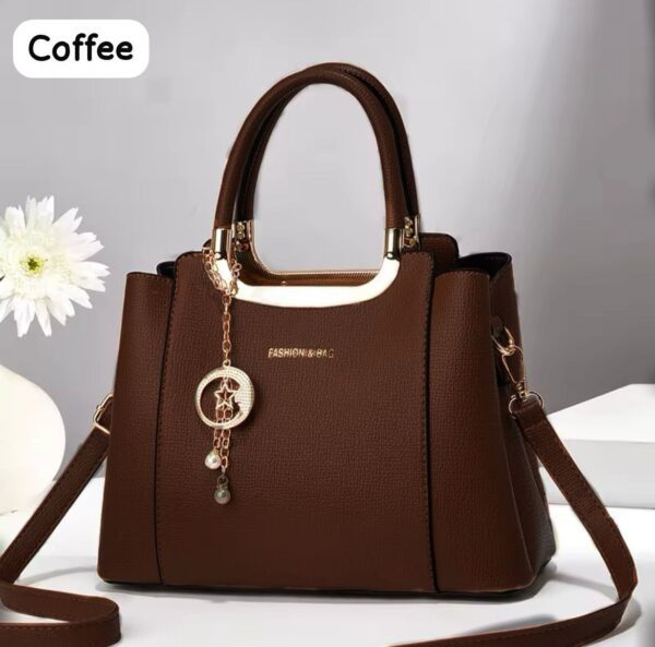 Elegant Handbag with Star Charm Pendant and Structured Design