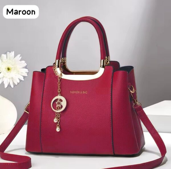 Elegant Handbag with Star Charm Pendant and Structured Design