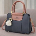 Elegant Dual Tone Handbag With Pom Pom Charm