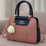 Elegant Dual Tone Handbag With Pom Pom Charm