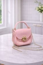 Polished Jelly Saddle Bag With Sculpted Metallic Clasp And Gold Tone Chain