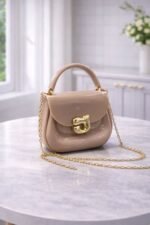 Polished Jelly Saddle Bag With Sculpted Metallic Clasp And Gold Tone Chain