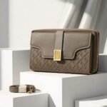 Luxe Quilted Zippered Clutch With Signature Metallic Clasp And Crossbody Strap